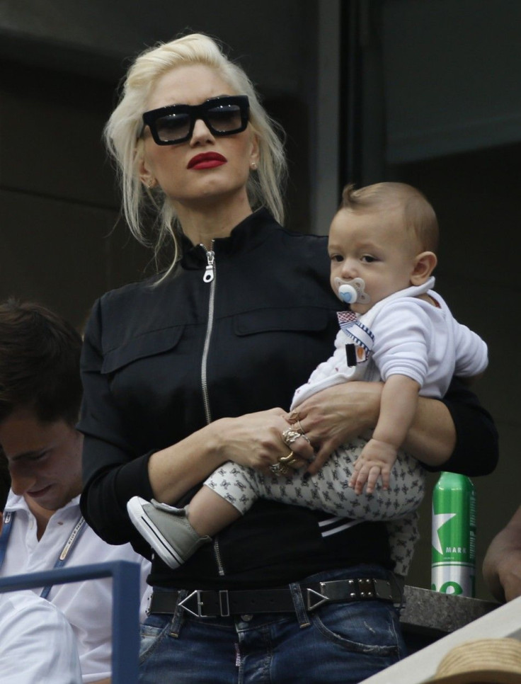 Singer Gwen Stefani holds her son Apollo as she attends the semi-final match between Marin Cilic of Croatia and Roger Federer of Switzerland at the 2014 U.S. Open tennis tournament in New York, September 6, 2014.