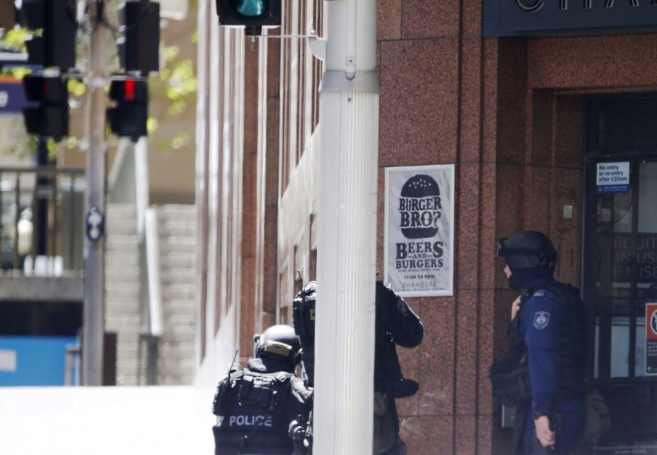 Police officers are seen at a corner near Lindt cafe in Martin Place