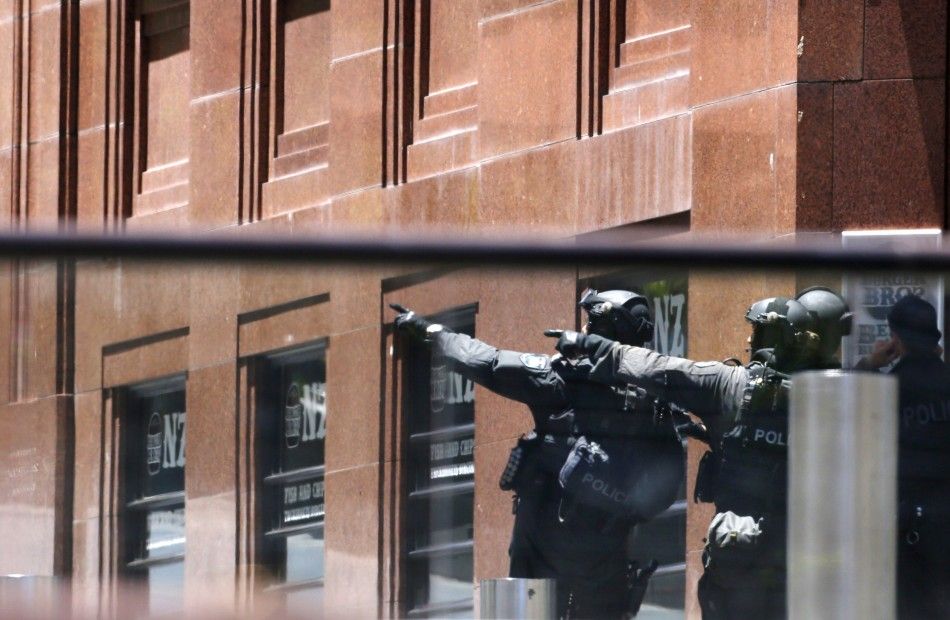 Police officers gesture near Lindt cafe in Martin Place
