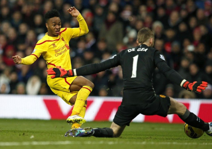 Manchester United goalkeeper David De Gea (R) makes a save from Liverpool's Raheem Sterling during their English Premier League soccer match at Old Trafford in Manchester, northern England December 14, 2014.