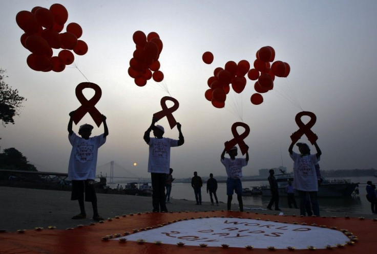 Children display ribbon cut-outs tied to balloons during an HIV/AIDS awareness campaign to mark World AIDS Day in Kolkata December 1, 2014. The world has finally reached &quot;the beginning of the end&quot; of the AIDS pandemic that has infected and kille