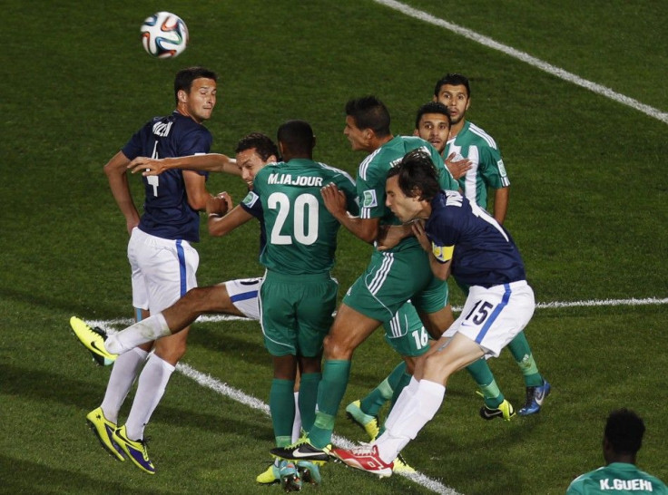 Raja Casablanca and Auckland City FC&#039;s players fight for the ball during their FIFA Club World Cup soccer match at Grand Stadium in Agadir December 11, 2013. Raja Casablanca, representing host nation Morocco, needed a stoppage-time goal from Abdelila