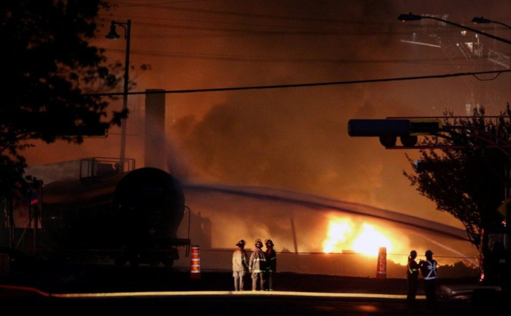 Firefighters look at a train wagon on fire at Lac Megantic, Quebec, July 6, 2013. Canadian police expect the death toll from a fatal fuel train blast in a small Quebec town to be more than the one person confirmed dead so far, a spokesman said on Saturday