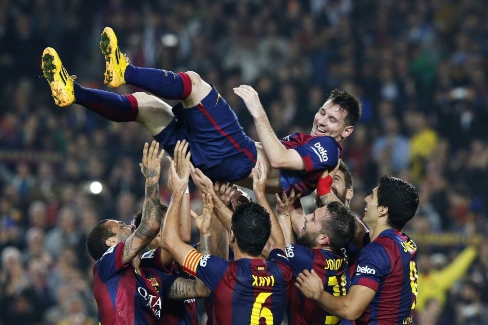 Barcelonas Lionel Messi celebrates his second goal with teammates during their Spanish first division soccer match against Sevilla at Nou Camp stadium in Barcelona November 22, 2014. Barcelona forward Messi set a La Liga scoring record of 253 goals 