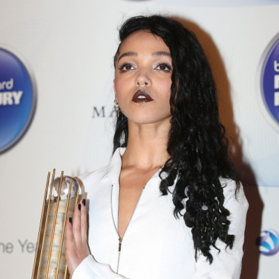 FKA twigs poses with her nominee trophy as she arrives at the 2014 Mercury Prize awards in London