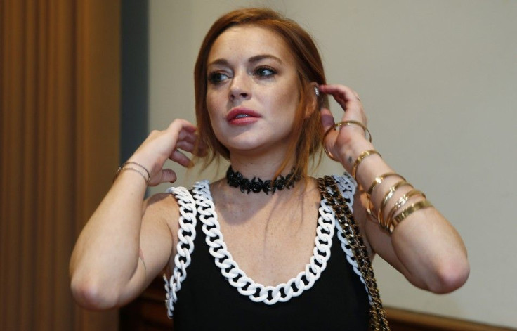 Actress Lindsay Lohan arrives for the presentation of the Moschino collection during its London Collections: Men show in London June 16, 2014.