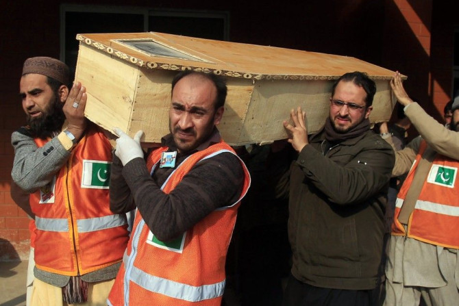 Rescue workers and a family member carry the coffin of a student who was killed during an attack by Taliban gunmen on the Army Public School in Peshawar