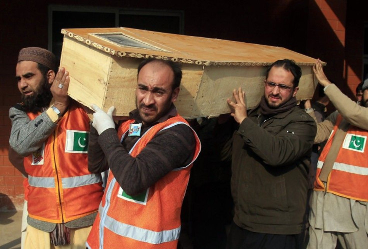Rescue workers and a family member carry the coffin of a student who was killed during an attack by Taliban gunmen on the Army Public School in Peshawar