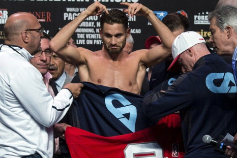 Chris Algieri (C) of the U.S. takes to the scale naked during an official weigh-in for his World Boxing Organisation (WBO) international 12-round welterweight title fight against Manny Pacquiao of the Philippines at the Venetian Macao hotel in Macau Novem