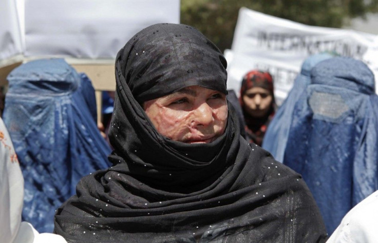 Momtaz, 16, a victim of an acid attack, participates in a protest against the recent public execution of a young woman, in Kabul