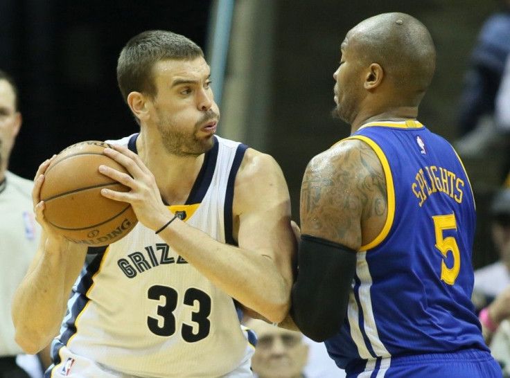 Dec 16, 2014; Memphis, TN, USA; Memphis Grizzlies center Marc Gasol (33) drives against Golden State Warriors forward Marreese Speights (5) at FedExForum. Grizzlies defeated the Warriors 105-98.