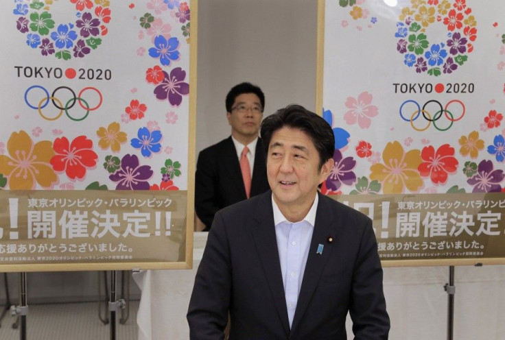 Japan&#039;s Prime Minister Shinzo Abe smiles as he reports to his cabinet members Tokyo&#039;s successful bid to host the 2020 Summer Olympics and Paralympics at the IOC meeting after returning from Buenos Aires, Argentina, during a cabinet meeting at th