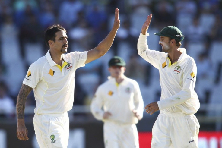 Australia&#039;s Mitchell Johnson (L) and Nathan Lyon celebrate the wicket of Dale Steyn (not in picture) during the third day of the third cricket test match against South Africa at Newlands Stadium in Cape Town, March 3, 2014.
