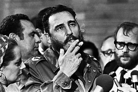 Fidel Castro smokes a cigar during interviews with the press in Havana