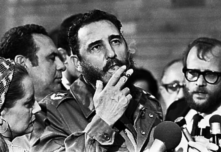 Fidel Castro smokes a cigar during interviews with the press in Havana