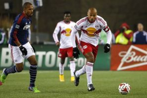 Foxborough, MA, USA; New York Red Bulls forward Thierry Henry (14) carries the ball past New England Revolution forward Teal Bunbury (10) during the second half of the Eastern Conference Championship at Gillette Stadium.