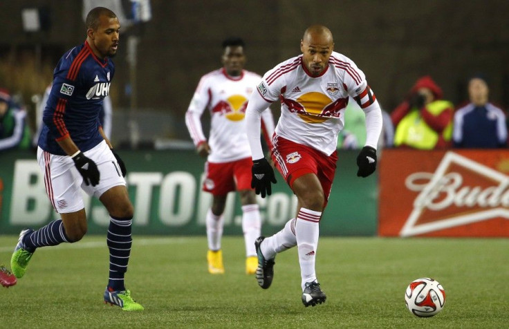 Foxborough, MA, USA; New York Red Bulls forward Thierry Henry (14) carries the ball past New England Revolution forward Teal Bunbury (10) during the second half of the Eastern Conference Championship at Gillette Stadium.