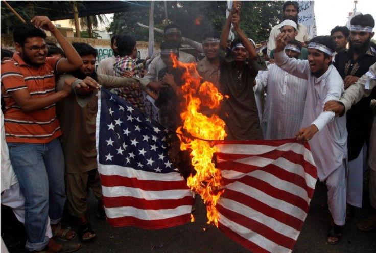 Supporters of the Jamaat-ud-Dawa Islamic organization burn the U.S. flag as they shout slogans during a protest, against U.S. drone attacks in the Pakistani tribal region
