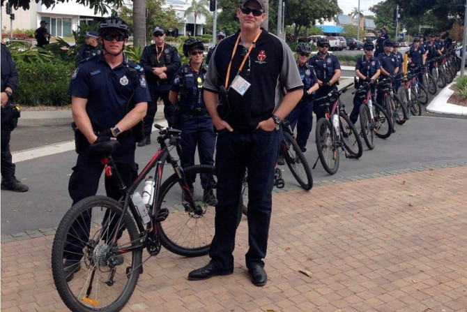 Police stand with their bicycles as they watch a small protest outside the venue of the G20 finance ministers and central bankers in the northern Australian city of Cairns