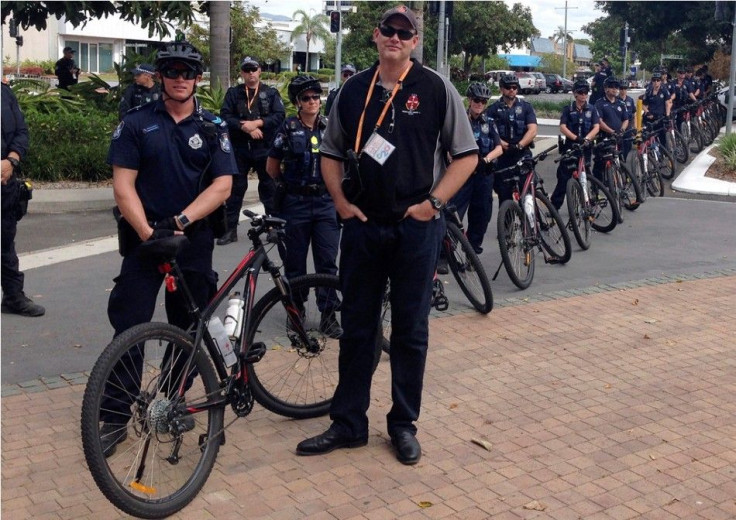 Police stand with their bicycles as they watch a small protest outside the venue of the G20 finance ministers and central bankers in the northern Australian city of Cairns