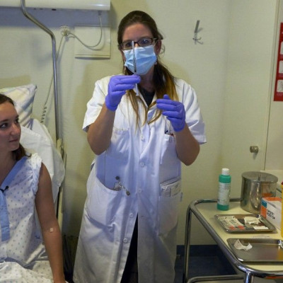 A nurse prepares a syringe containing an experimental Ebola virus vaccine.