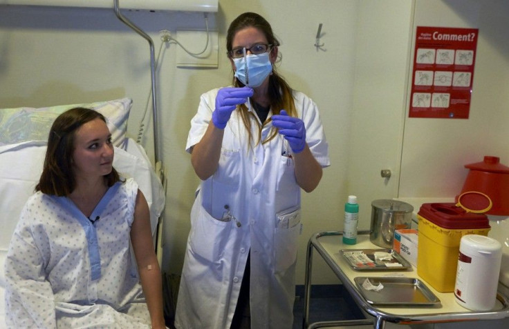 A nurse prepares a syringe containing an experimental Ebola virus vaccine.