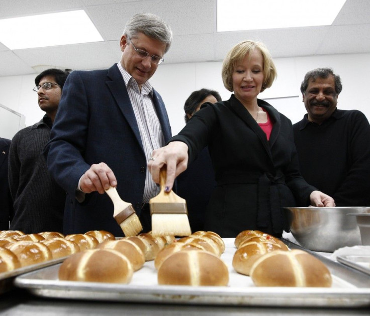 Conservative leader and Canada&#039;s Prime Minister Stephen Harper and his wife Laureen glaze hot cross buns during a campaign stop at a bakery in Mississauga, Ontario April 23, 2011. Canadians will head to the polls in a federal election on May 2. REUTE