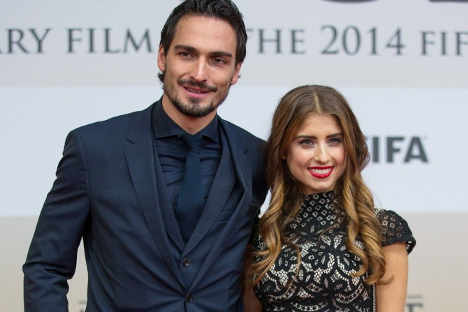 Mats Hummels of the German national soccer team and his girlfriend Cathy Fischer pose at the world premiere of &quot;Die Mannschaft&quot; (The Team) at the Sony Center in Berlin November 10, 2014.