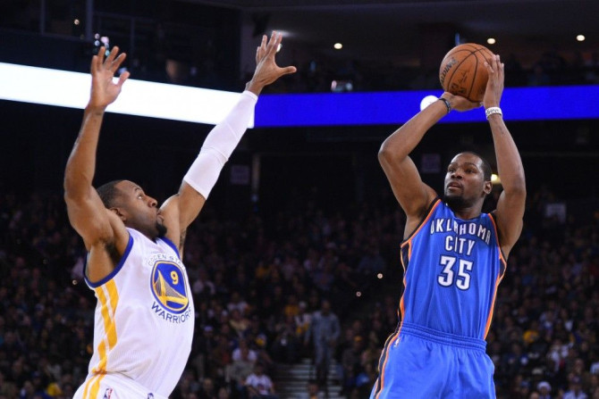 December 18, 2014; Oakland, CA, USA; Oklahoma City Thunder forward Kevin Durant (35) shoots the basketball against Golden State Warriors guard Andre Iguodala (9) during the second quarter at Oracle Arena.
