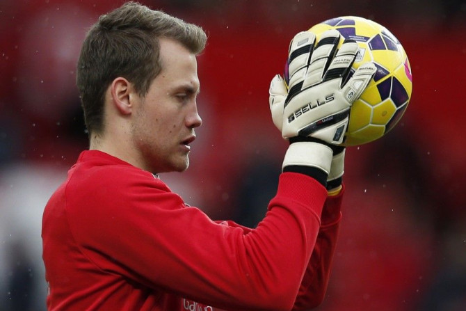 Liverpool goalkeeper Simon Mignolet who has been dropped, warms up before their English Premier League soccer match against Manchester United at Old Trafford in Manchester, northern England December 14, 2014.