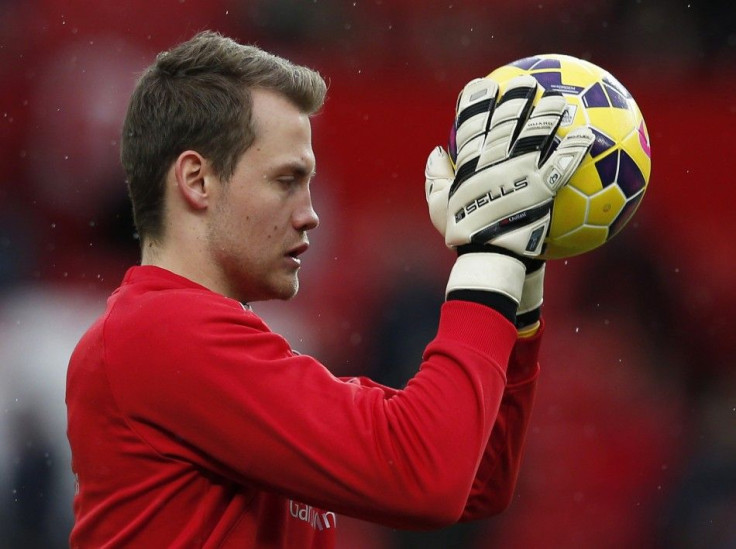 Liverpool goalkeeper Simon Mignolet who has been dropped, warms up before their English Premier League soccer match against Manchester United at Old Trafford in Manchester, northern England December 14, 2014.