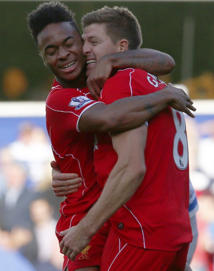 Liverpool&#039;s Raheem Sterling (L) celebrates with Steven Gerrard after his cross led to the winning own goal during their English Premier League soccer match against Queens Park Rangers at Loftus Road in London October 19, 2014.