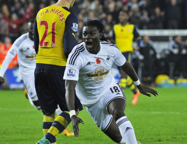 Swansea City's Bafetimbi Gomis celebrates his goal during their English Premier League soccer match against Arsenal at the Liberty Stadium in Swansea, Wales November 9, 2014.