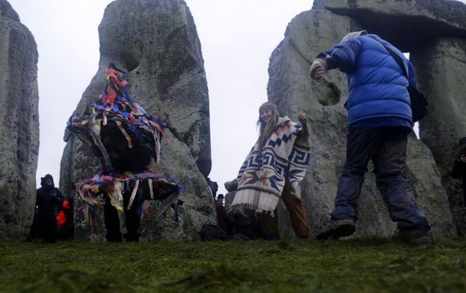 Revellers dance as they celebrate the winter solstice at Stonehenge in Amesbury, southern England December 21, 2013