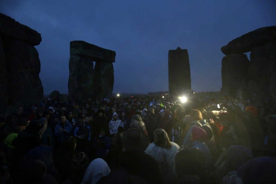 Druids and revellers sing incantations as they celebrate the winter solstice at Stonehenge in Amesbury, southern England December 21, 2013. 