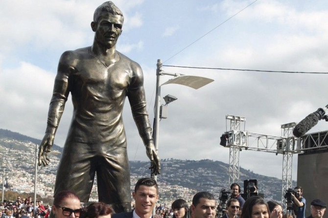 Portugal&#039;s Cristiano Ronaldo (C) and his family members pose under his statue during the unveiling of the statue at a tribute ceremony held in his city of birth, in Funchal December 21, 2014. REUTERS/Duarte Sa