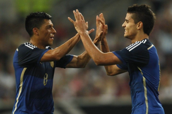 Argentina&#039;s Enzo Perez (L) and Erik Lamela celebrate after Lamela scored a second goal against Germany during their friendly soccer match in Duesseldorf September 3, 2014.