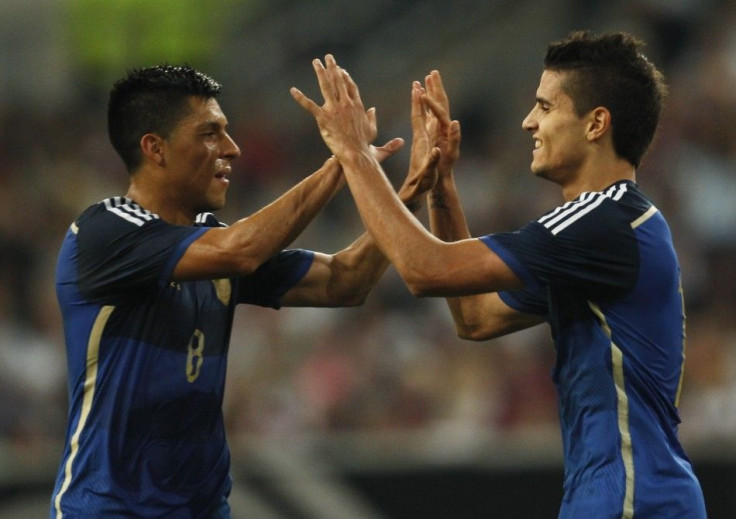 Argentina&#039;s Enzo Perez (L) and Erik Lamela celebrate after Lamela scored a second goal against Germany during their friendly soccer match in Duesseldorf September 3, 2014.