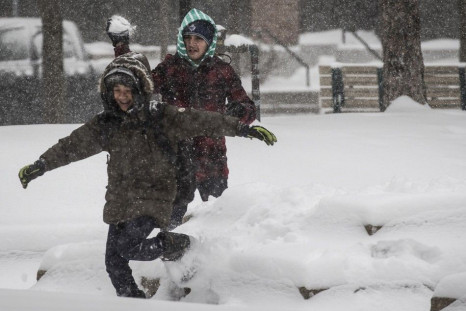 Children play as large amounts of snow fall in Toronto