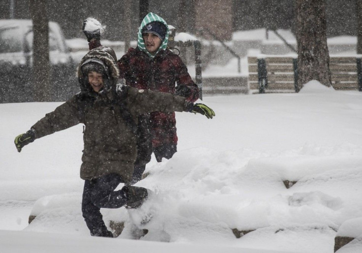 Children play as large amounts of snow fall in Toronto