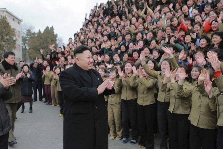 North Korean leader Kim Jong Un (C) smiles as he gives field guidance at the Kim Jong Suk Pyongyang Textile Mill in this undated photo released by North Korea's Korean Central News Agency (KCNA) in Pyongyang December 20, 2014.