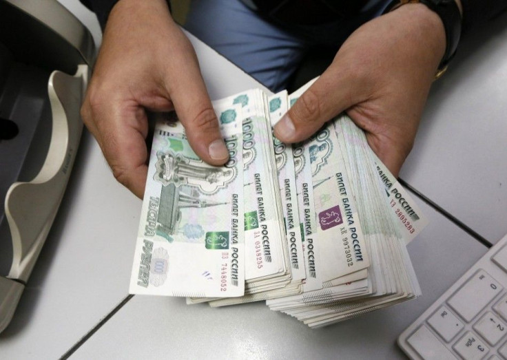 An employee counts Russian ruble banknotes at a private company's office in Krasnoyarsk, Siberia, December 17, 2014. 