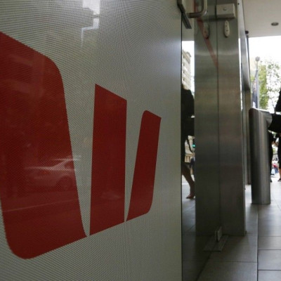 A customer walks from a Westpac bank branch in Sydney November 3, 2014. Australia's Westpac Banking Corp booked a fifth straight year of record profit with an 8 percent rise in full-year cash earnings on robust loan growth and declines in bad debts.
