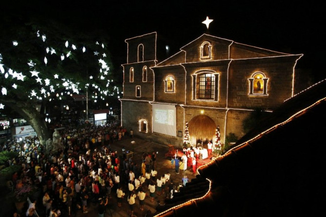 Devotees take part in the first of a nine-day pre-dawn mass, locally called &quot;Misa de Gallo&quot;, before Christmas at a church in Las Pinas, Metro Manila December 16, 2014. The pre-dawn mass is considered one of the most popular traditions among Fili