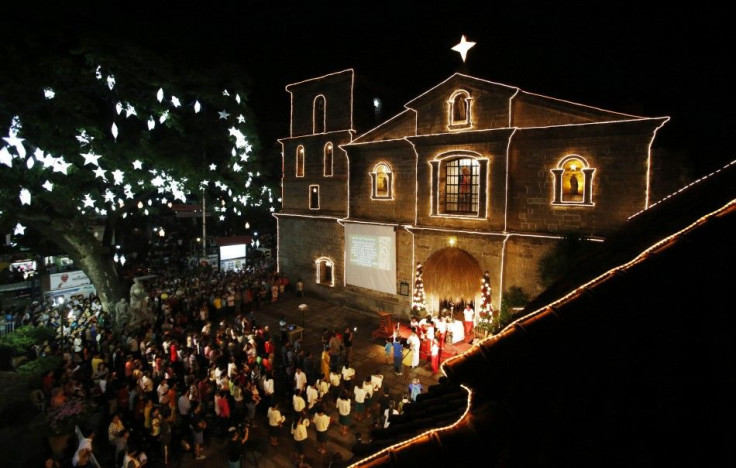 Devotees take part in the first of a nine-day pre-dawn mass, locally called &quot;Misa de Gallo&quot;, before Christmas at a church in Las Pinas, Metro Manila December 16, 2014. The pre-dawn mass is considered one of the most popular traditions among Fili