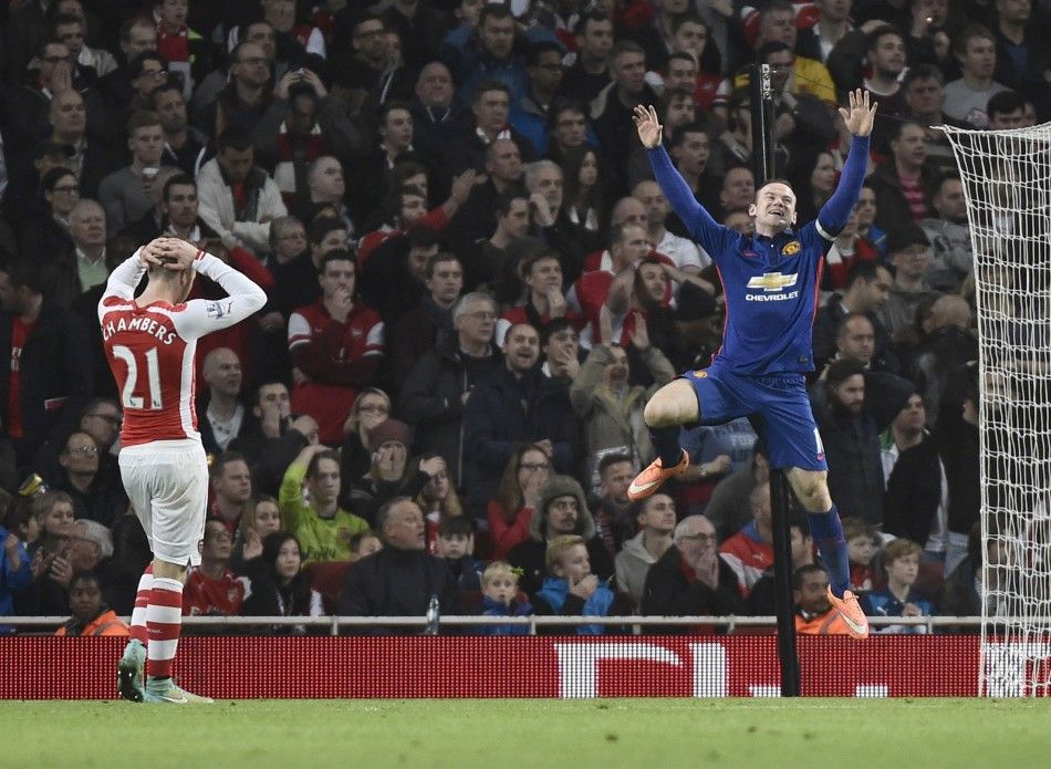 Manchester Uniteds Wayne Rooney R celebrates an own goal by Arsenals Kieran Gibbs during their English Premier League soccer match at the Emirates Stadium in London November 22, 2014. 