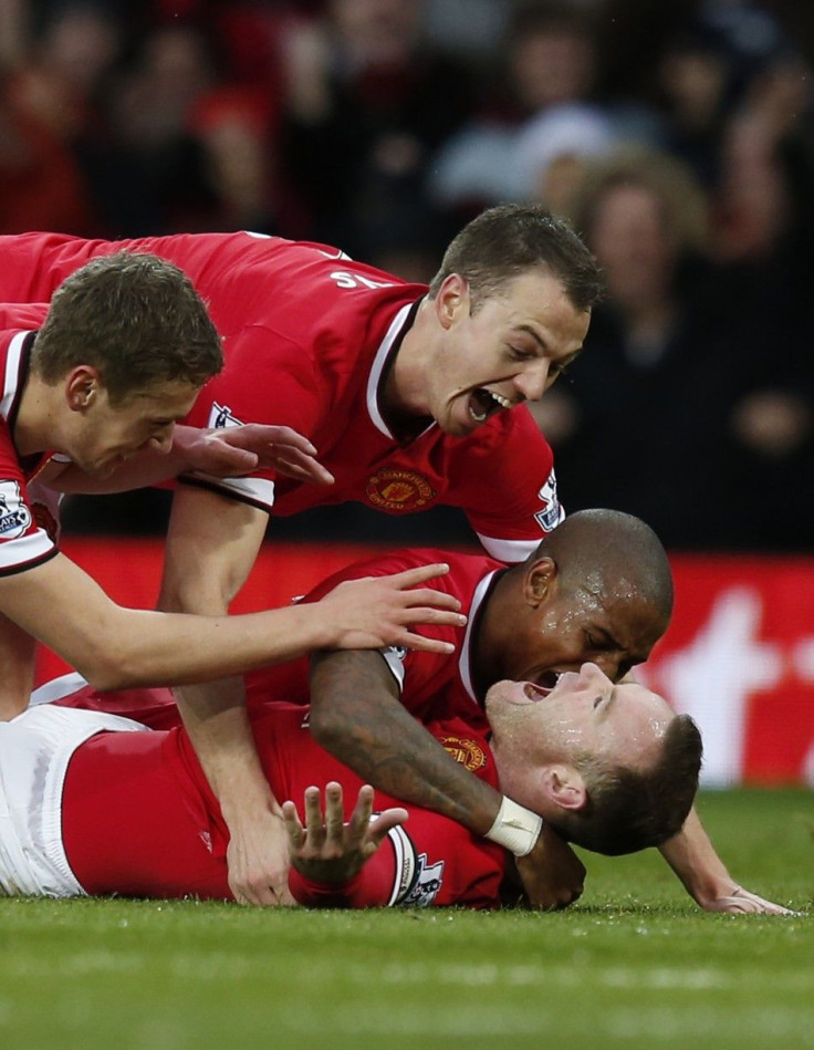 Manchester, United KingdomManchester United's Wayne Rooney (on ground) celebrates with Michael Carrick (L), Jonny Evans (top) and Ashley Young, after scoring the opening goal during their English Premier League soccer match against Liverpool at Old Traffo