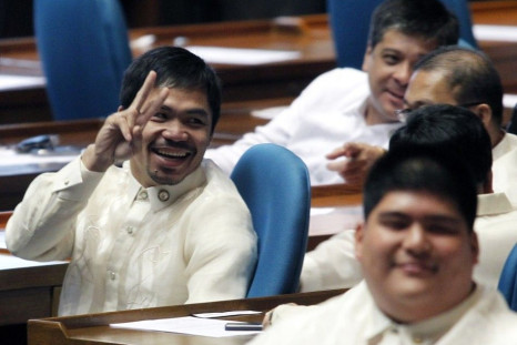 Newly elected Philippine congressman and world boxing champion Manny Pacquiao gives a peace sign after he votes for the new Speaker during the opening of the 15th Philippine Congress in Quezon City, Metro Manila July 26, 2010. Philippine President Benigno