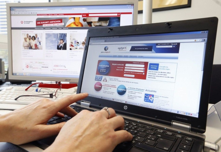 An employee of French National Agency for Employment (Pole Emploi) works simultaneously on French and German agencies for employement internet sites, at the joint German-French job center office in Kehl, Germany, on the French-German border near Strasbour