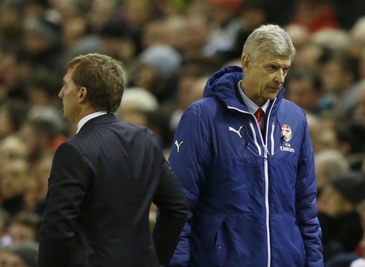 Arsenal manager Arsene Wenger (R) and Liverpool manager Brendan Rodgers stand next to each other during their English Premier League soccer match at Anfield in Liverpool, northern England December 21, 2014.